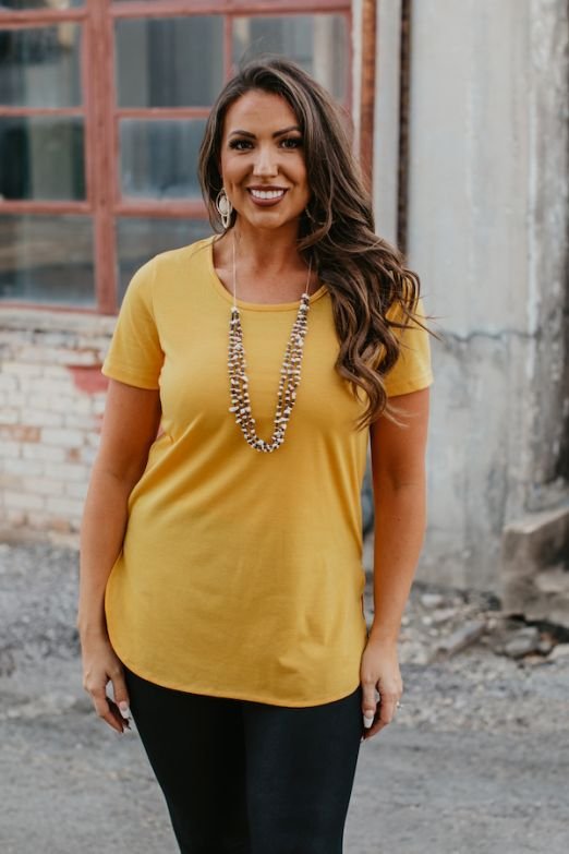 ESSENTIAL MUSTARD SHORT SLEEVE TOP WITH CURVED HEM RELAXED FIT SCOOP NECK WITH SIDE SLIT